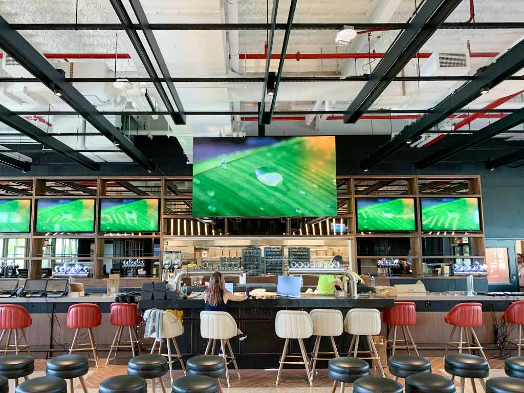 This is an image that showcases an indoor LED Display installed in a restaurant bar as an indoor led commercial display
