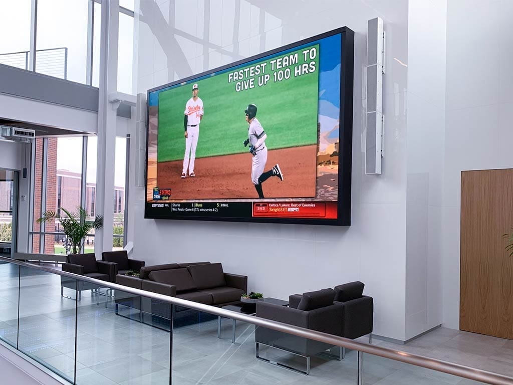 This image showcases an indoor LED display installed in a corporate building lobby